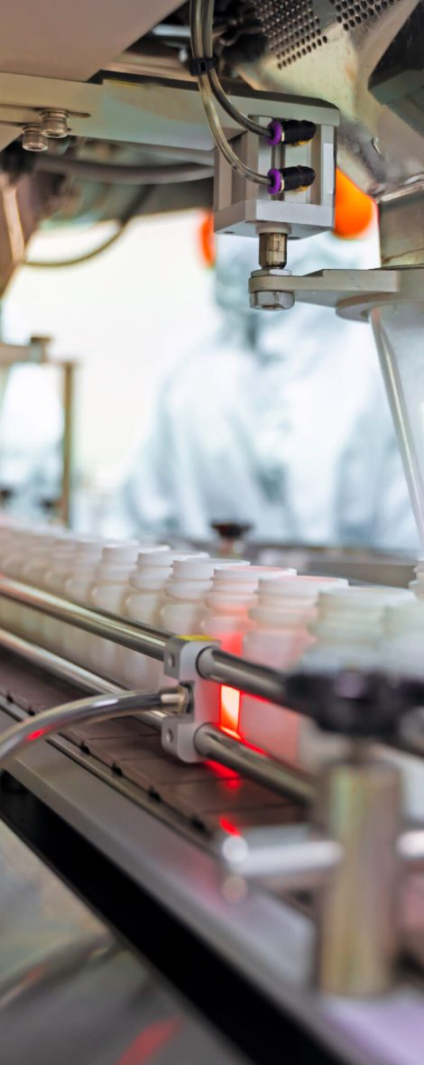 Transfer medicine bottles on the conveyor belt in the pharmaceutical industry, industrial machinery for the quality of medical products. Industrial concept and factory technology.shallow focus effect.